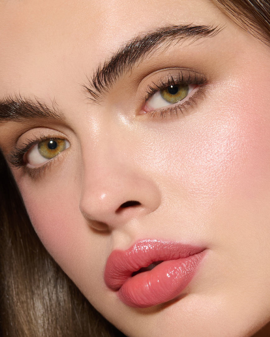 Close-up of a model's face, wearing Fawn Eyeshadow Palette, with a neutral background