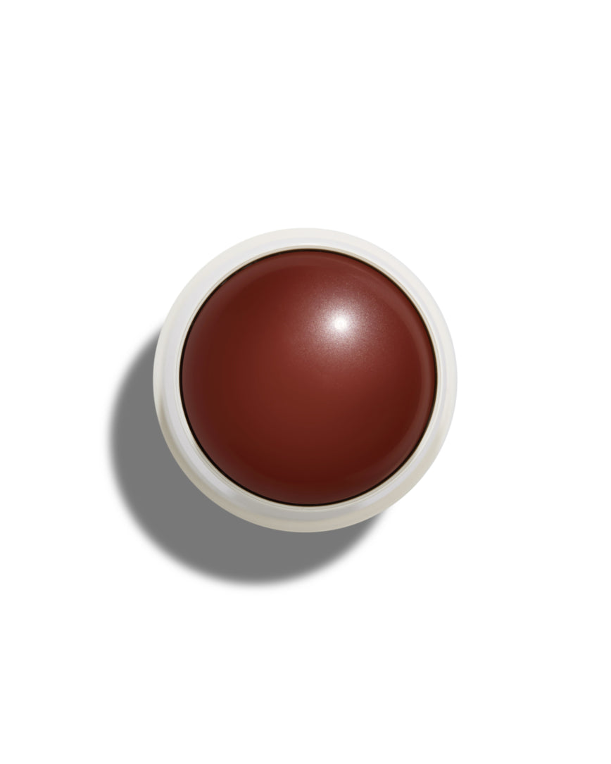 Cinnamon Bun Velatura Balm with white casing on a white background.