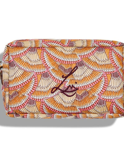 A rectangular beauty bag on a white background. The bag is made using Liberty print fabric which looks like overlapping fans that have brown, beige, orange, white and pink stripes. Lisa Eldridge’s logo is embroidered on the front and the bag has a gold circular zip.