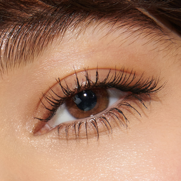 Close-up of a person's eye with long, thick eyelashes
