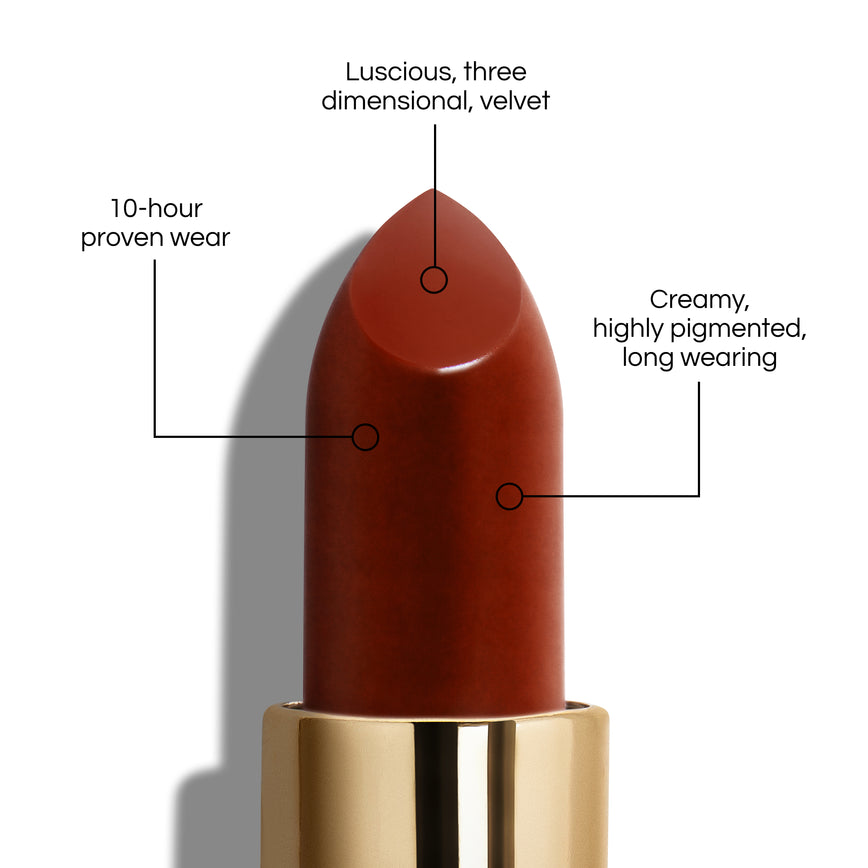 True Velvet Lip Colour bullet close-up, with text demonstrating it's benefits: Lucious, three dimensional, velvet. 10-hour proven wear. Creamy, highly pigmented, long wearing. In shade Cinnabar.