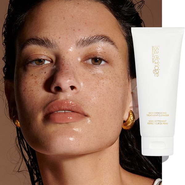 Model with a slick complexion due to Seamless Skin Enhancing Treatment Cleanser, with product pack in the foreground.