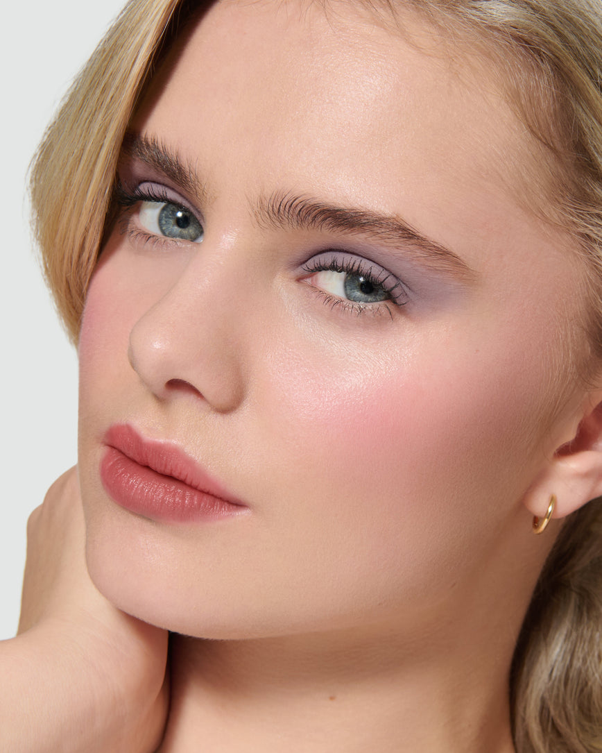 Close up of a model wearing Maude Liquid Silk Eyeshadow on a neutral background
