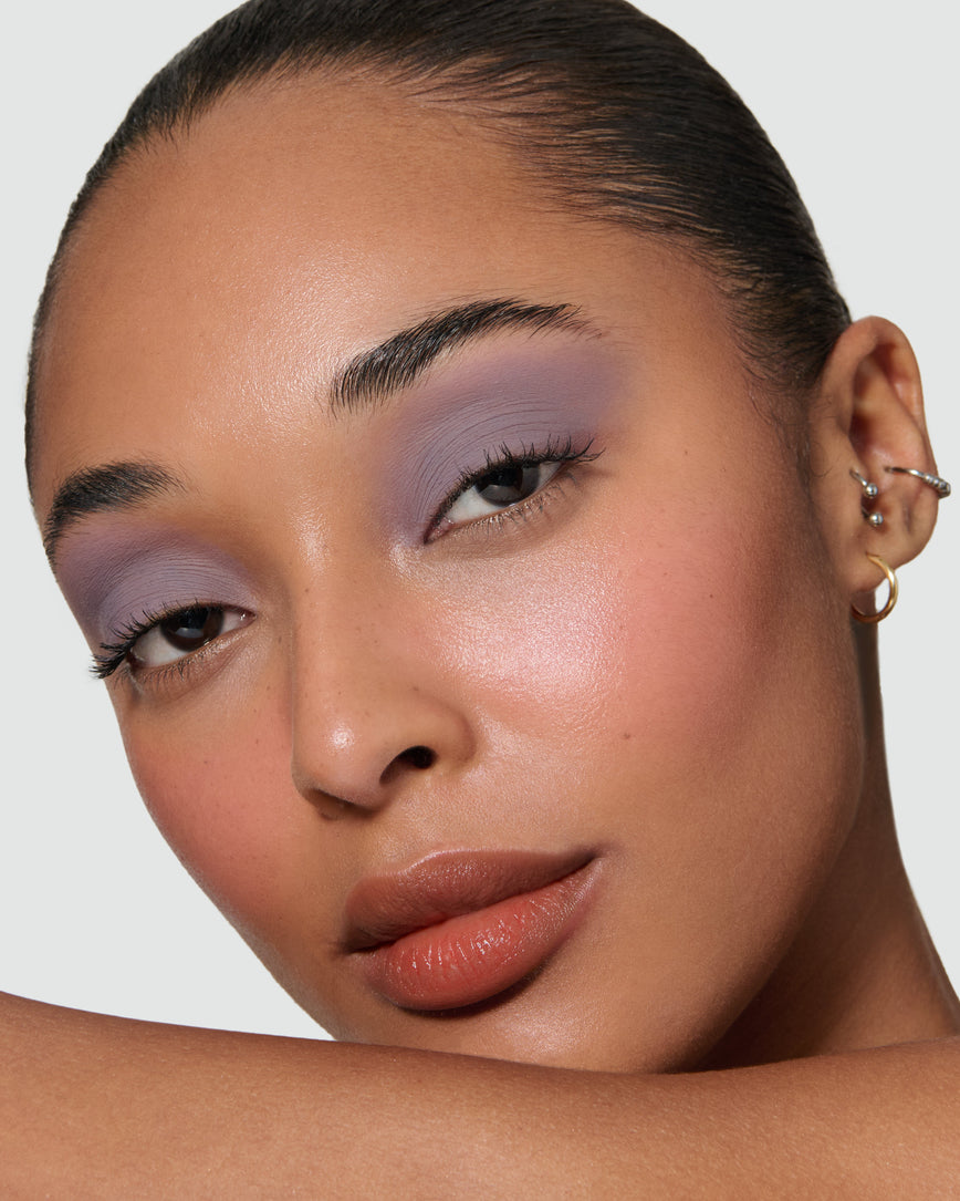 Close up of a model wearing Maude Liquid Silk Eyeshadow on a neutral background