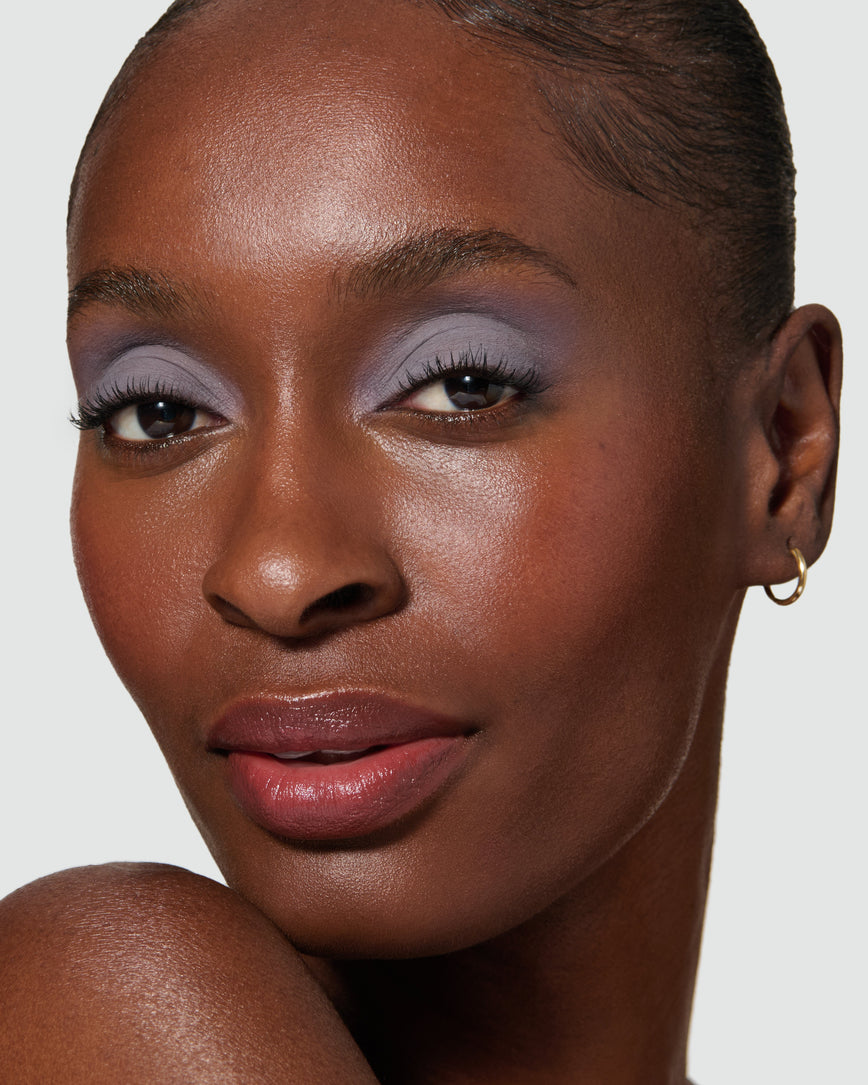 Close up of a model wearing Maude Liquid Silk Eyeshadow on a neutral background