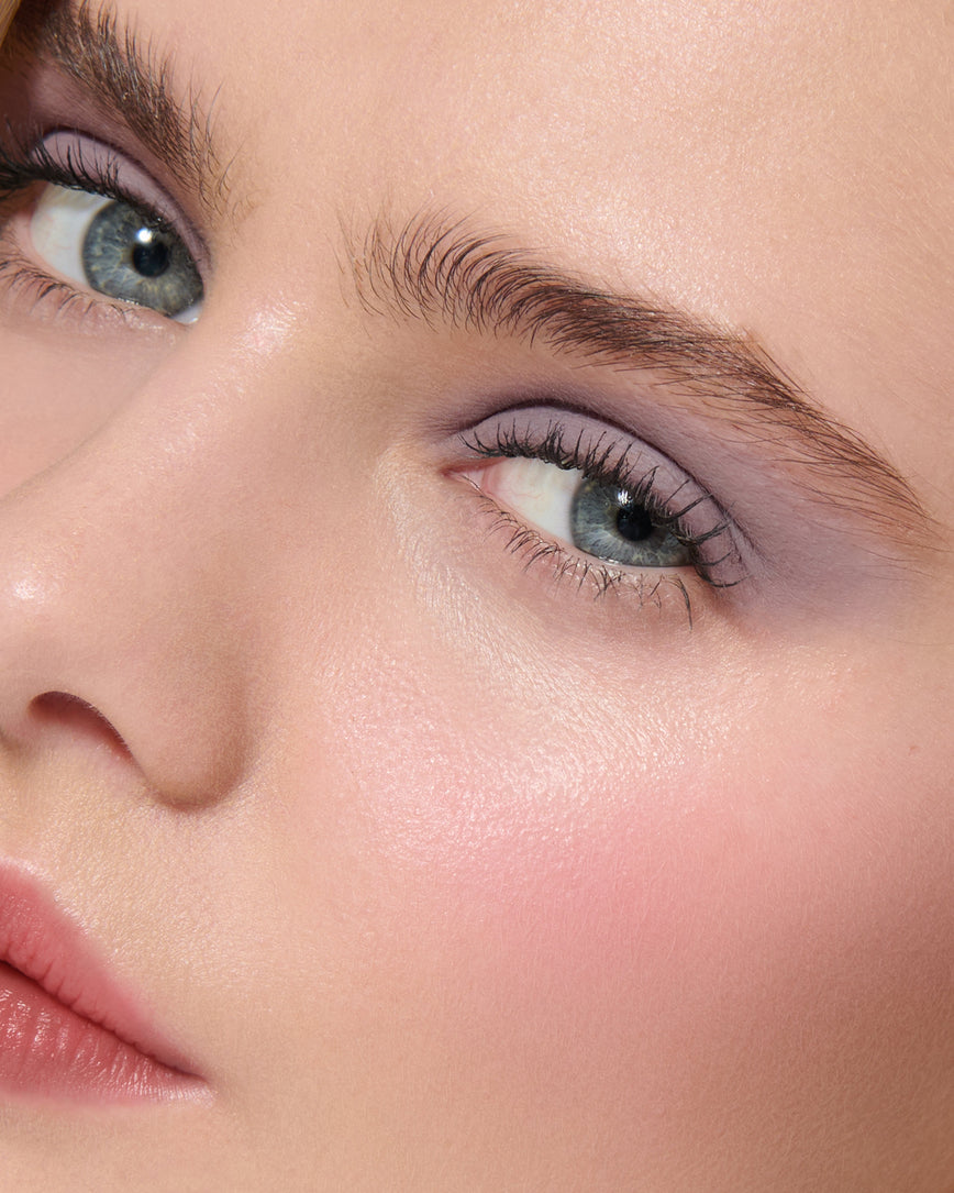 Extreme close up of a model wearing Maude Liquid Silk Eyeshadow on a neutral background