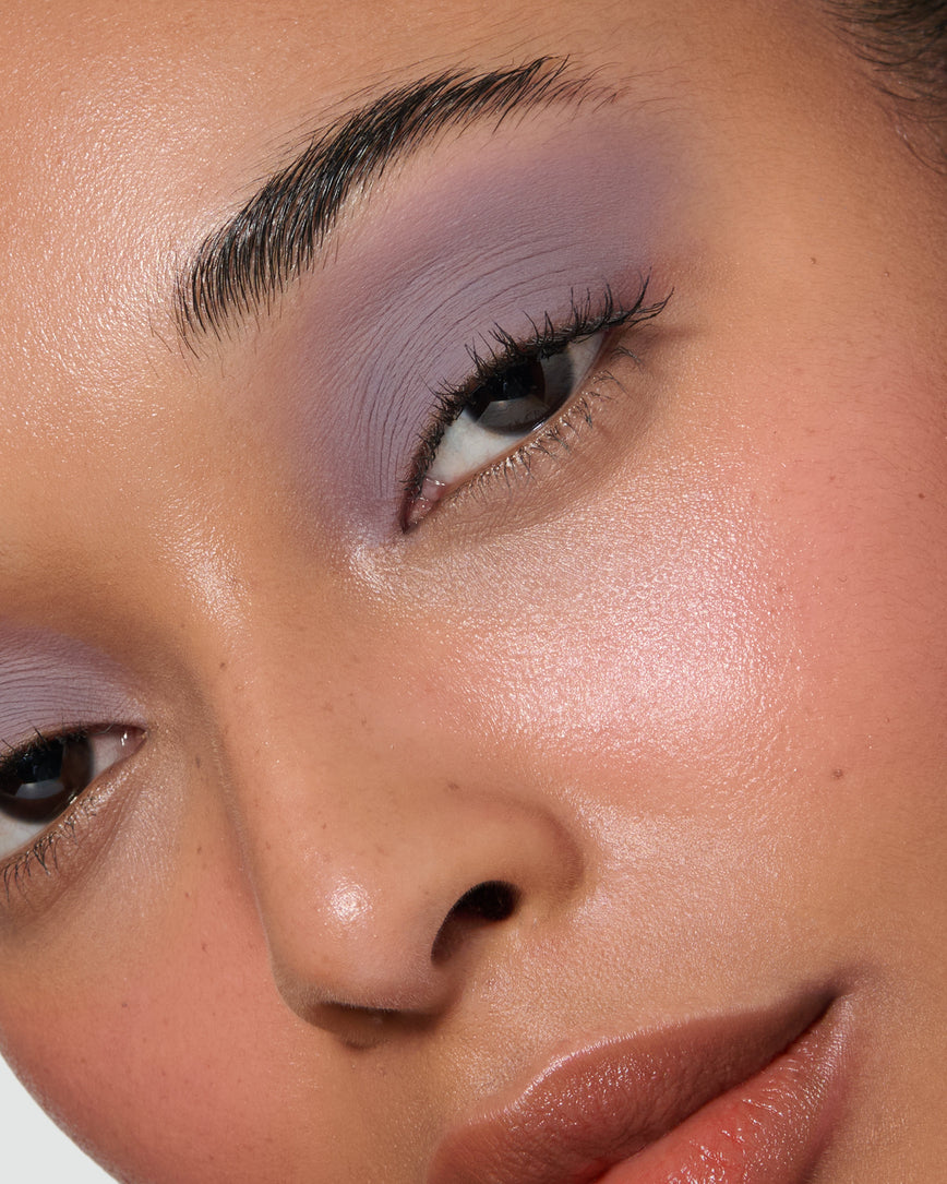 Extreme close up of a model wearing Maude Liquid Silk Eyeshadow on a neutral background