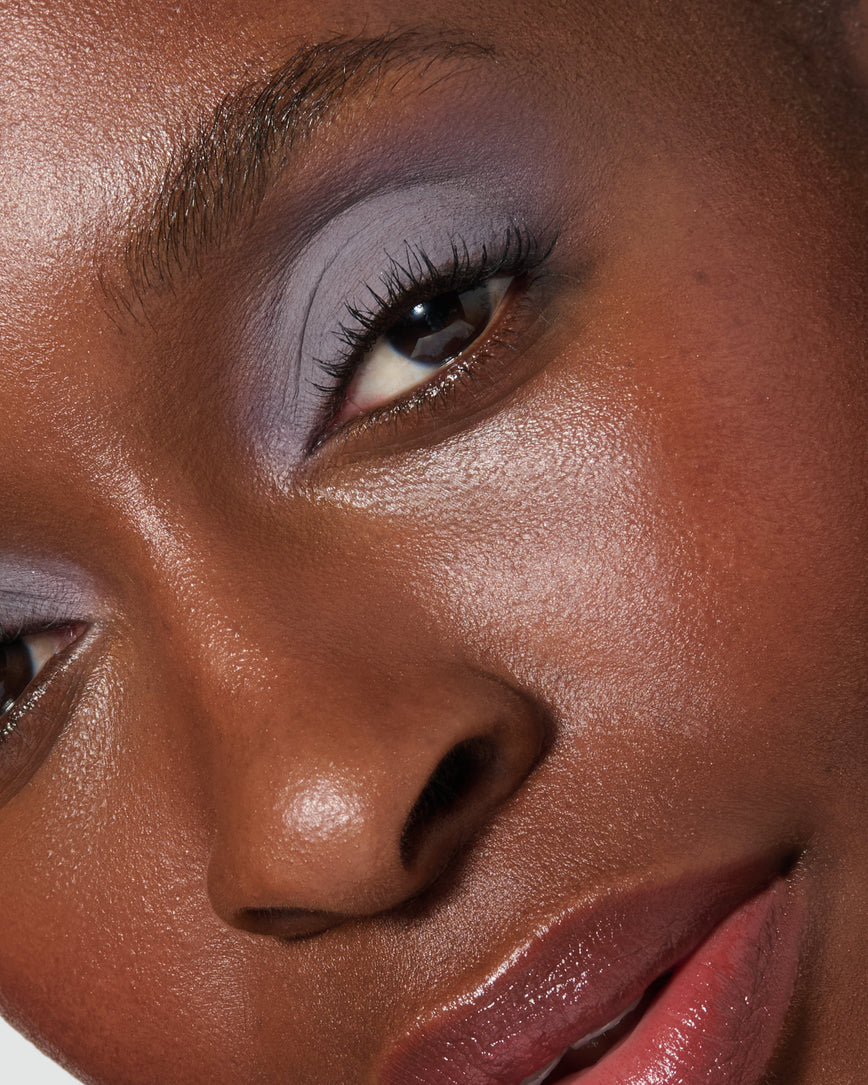 Extreme close up of a model wearing Maude Liquid Silk Eyeshadow on a neutral background