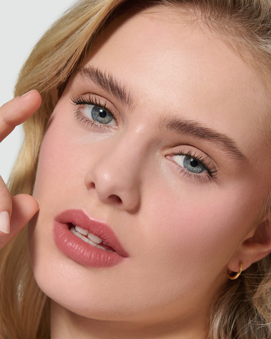 Close up of a model wearing Silvia Liquid Silk Eyeshadow on a neutral background