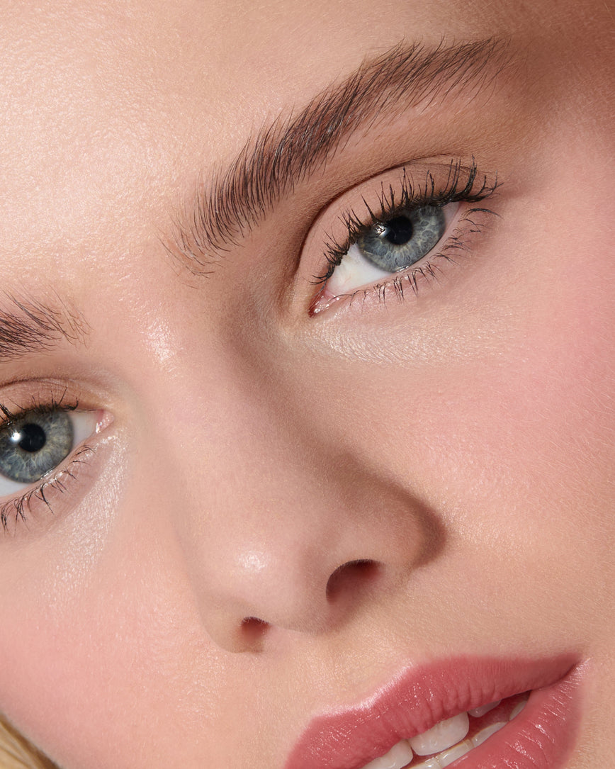 Extreme close up of a model wearing Silvia Liquid Silk Eyeshadow on a neutral background