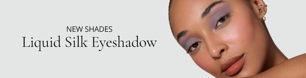 Model wearing a purple Liquid Silk Liquid Eyeshadow, on a neutral background, with text: New shades, Liquid Silk Eyeshadow