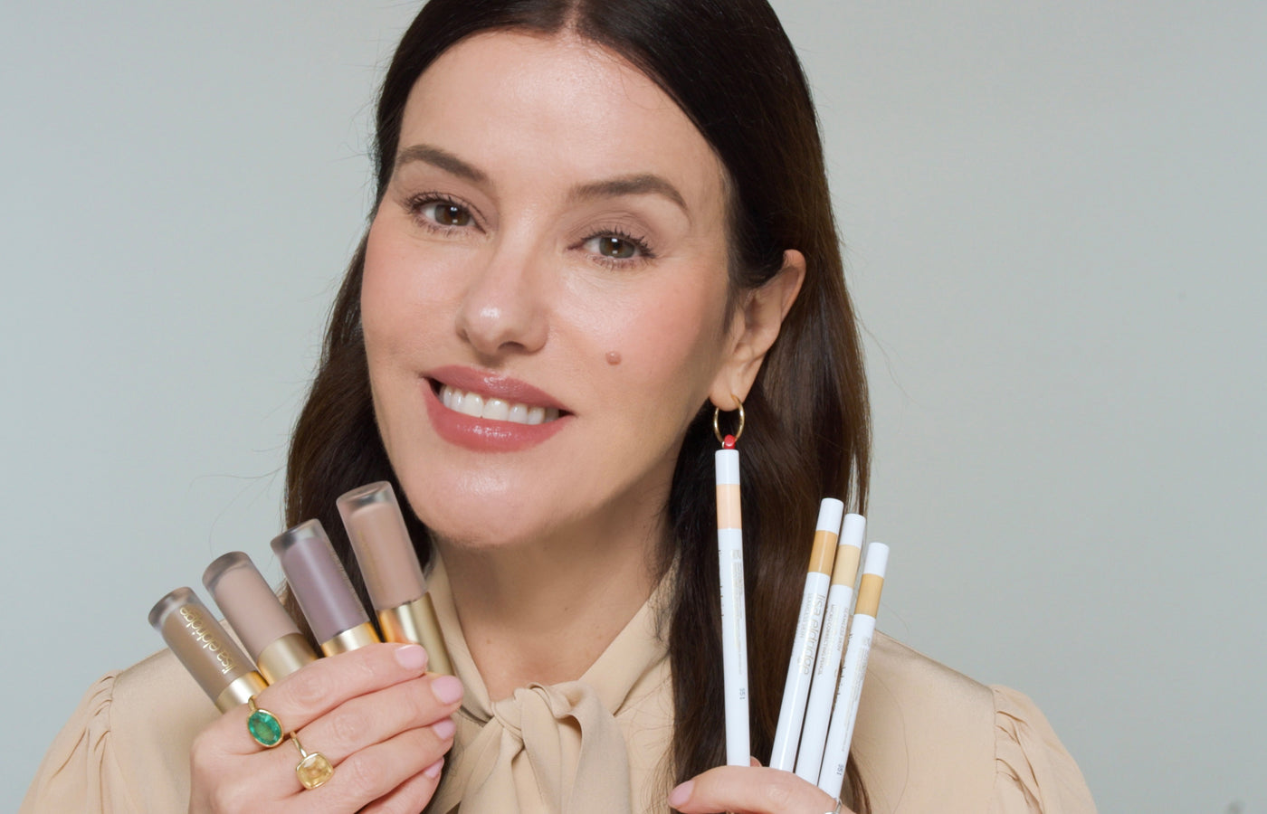 Lisa holding the new Liquid Silk products against a plain background 