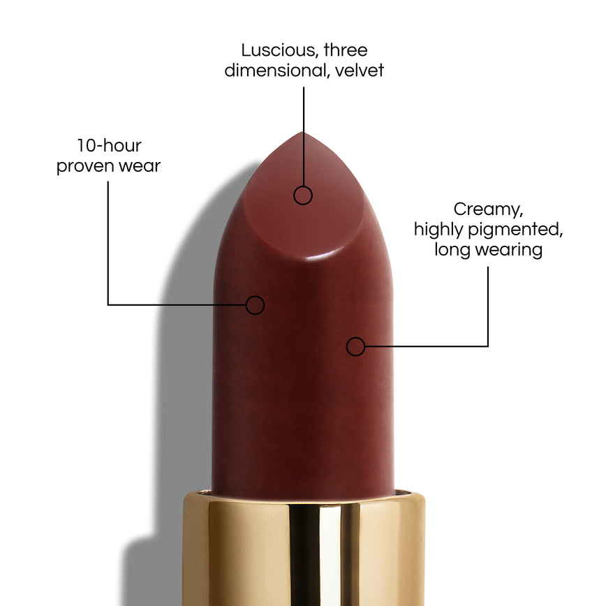 True Velvet Lip Colour bullet close-up, with text demonstrating it's benefits: Lucious, three dimensional, velvet. 10-hour proven wear. Creamy, highly pigmented, long wearing. In shade Sorcery.
