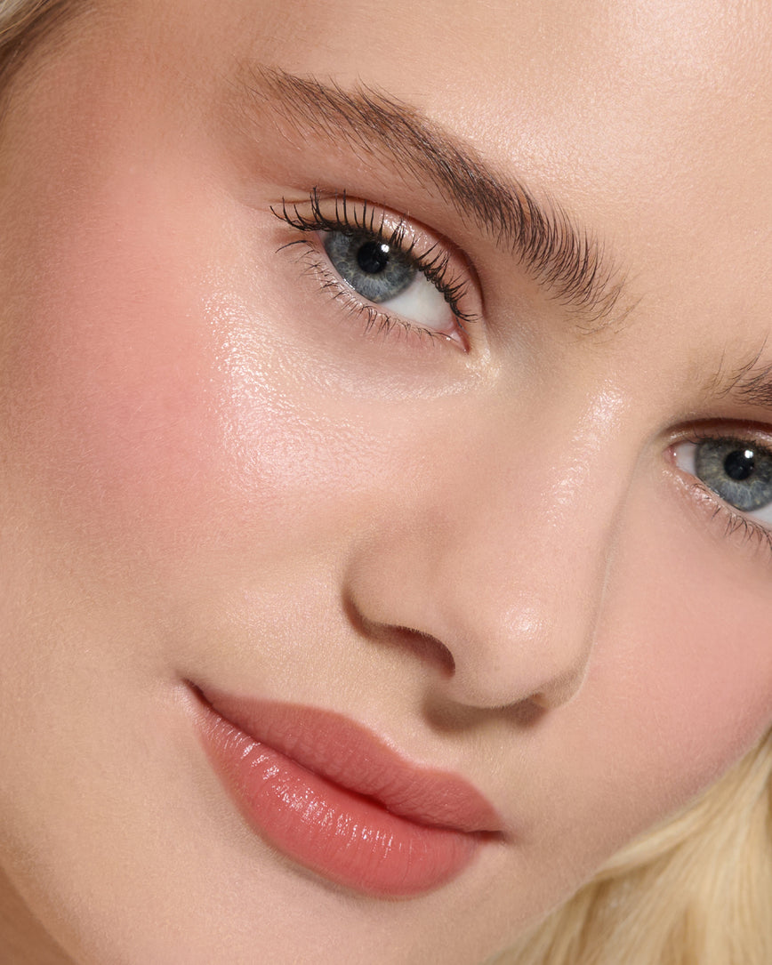 Extreme Close-up of a model's face with a neutral background, wearing Velatura Balm in shade Cinnamon Bun