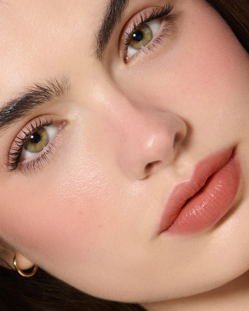 Extreme Close-up of a model's face with a neutral background, wearing Velatura Balm in shade Cinnamon Bun