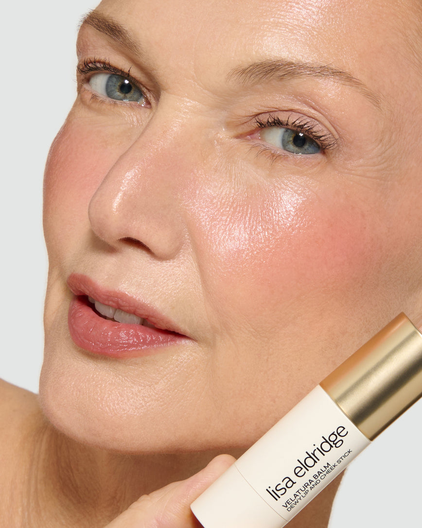 Model holding a Lisa Eldridge Velatura Balm product, with a neutral background
