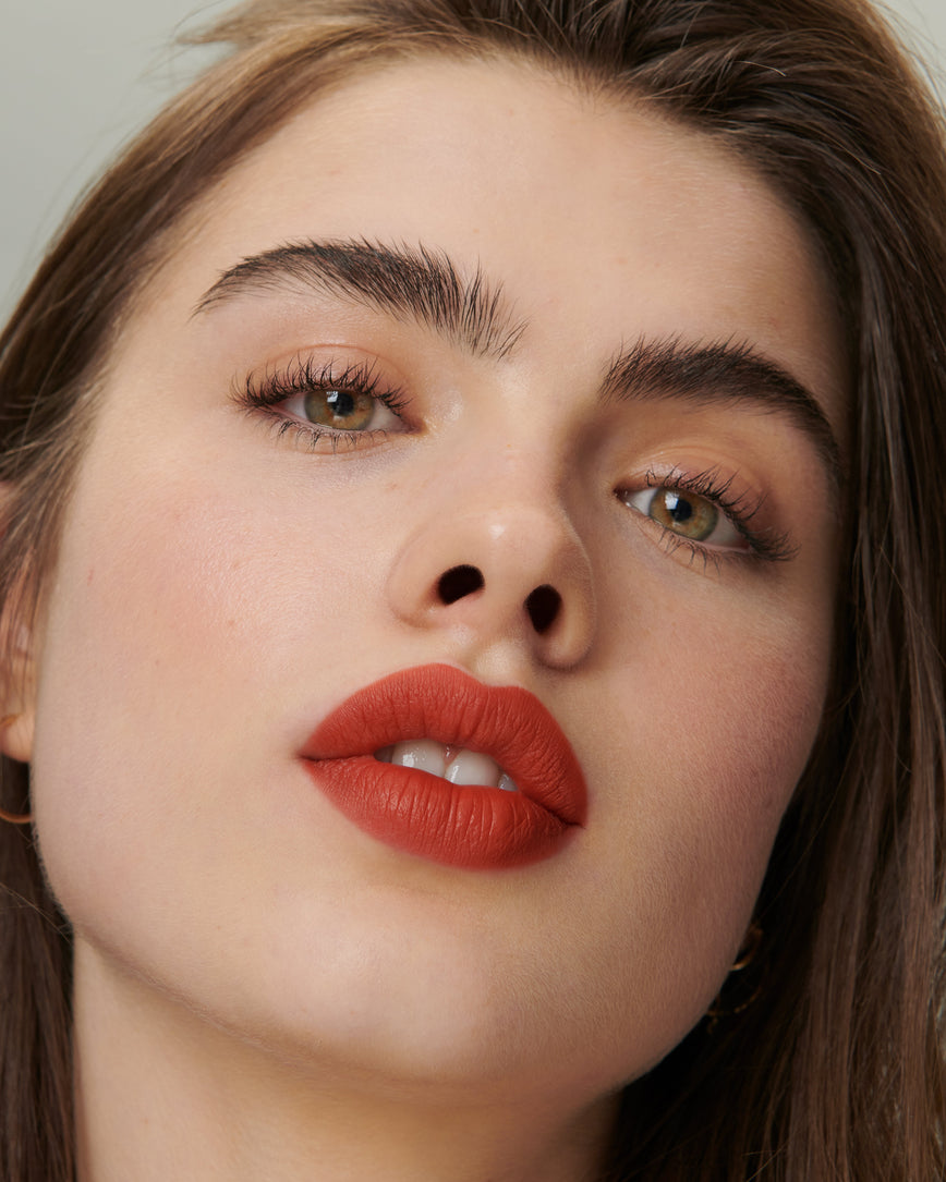 Lisa Eldridge Velveteen Liquid Lipstick in shade Dragon pictured on model
