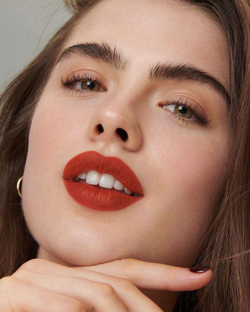 Lisa Eldridge Velveteen Liquid Lipstick in shade Dragon pictured on model