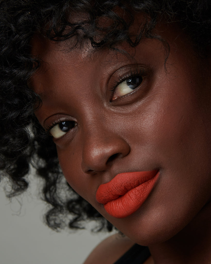 Lisa Eldridge Velveteen Liquid Lipstick in shade Dragon pictured on model