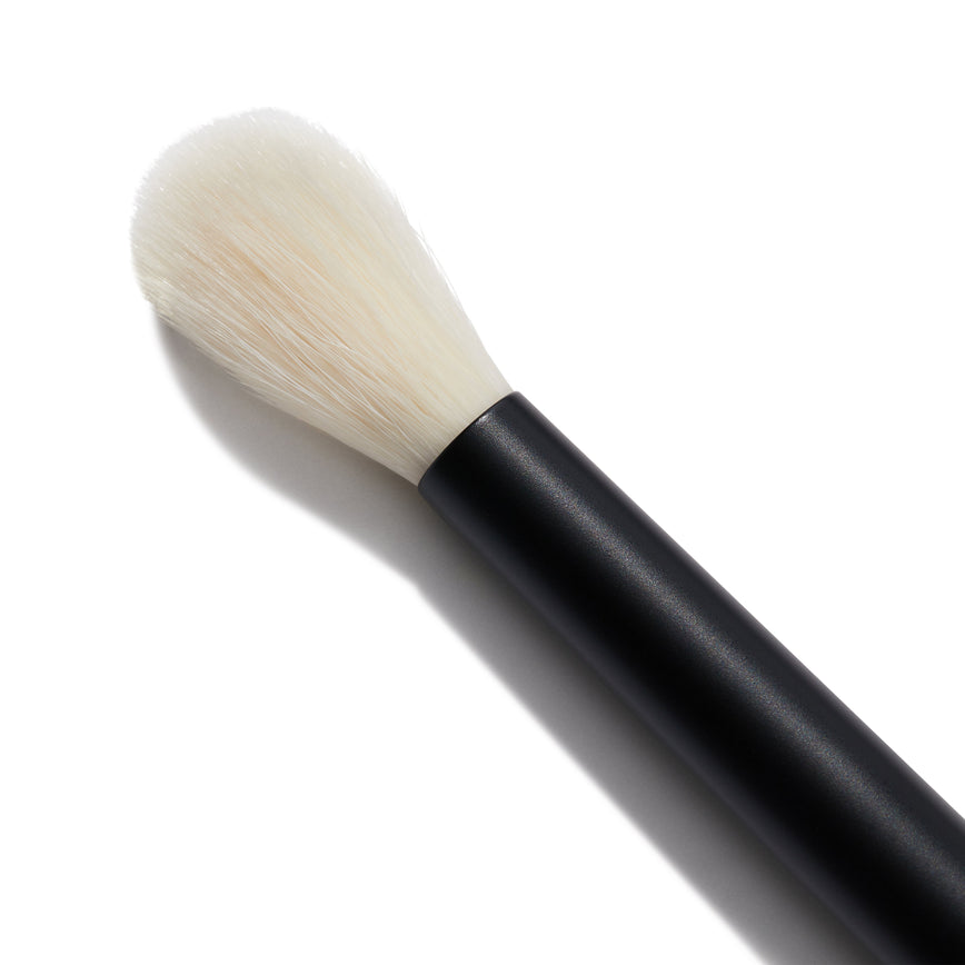 Close up of the No. 9 Seamless Blend Brush. You can see the long, tapered white bristles
